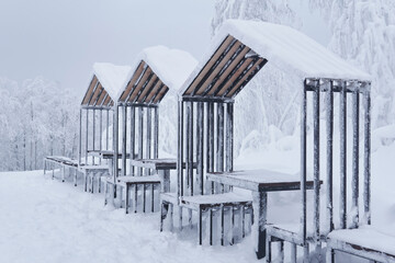 street furniture - gazebos with picnic tables - in a frosty winter park