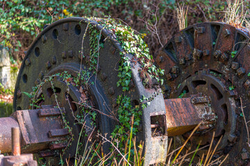 Old China Clay mining machinery reclaimed by nature as the ivy grows over it
