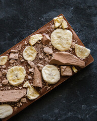 Handmade chocolate with pieces of freeze-dried fruit, banana and dry ice cream
