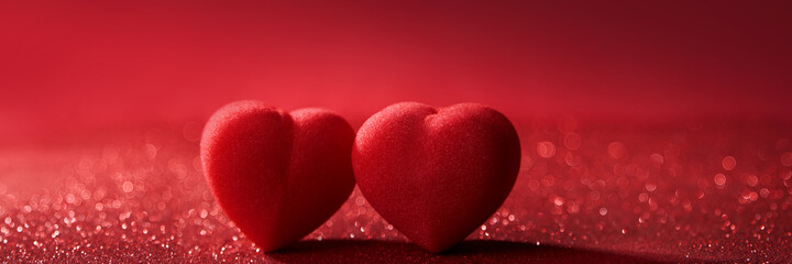 Two Hearts on top of Red Glitter In Shiny Bokeh Background - Valentine's Day Concept