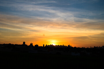 Photos of the sunset at the end of the day with the outline of the buildings in londrina, parana, brazil