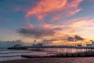 A fiery sky above the beach and pier at Worthing, Sussex, UK at sunset