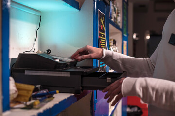 Close up bartender's hands  typing on cash register