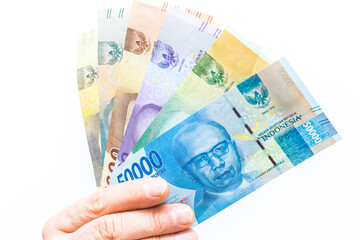 The currency of Indonesia, Rupiah, File of banknotes held in the hand