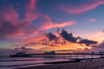 The sunset above the Victorian pier at Worthing, Sussex, UK