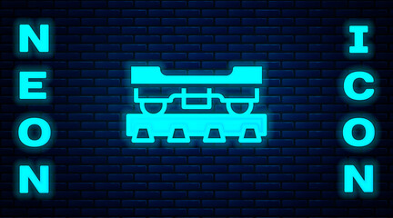 Glowing neon Cargo train wagon icon isolated on brick wall background. Freight car. Railroad transportation. Vector.