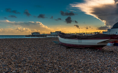 Naklejka premium A view across the beach out to sea at Worthing, Sussex, UK at sunset