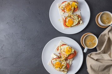 Dietary bread with fried egg and tomato. Top view with space for text.