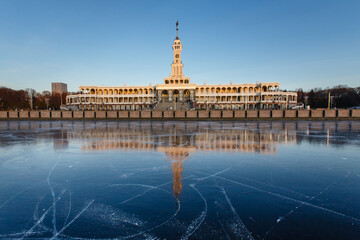 River station of Moscow in winter. Reflections of the pier buildings on the fresh ice of the Moscow...