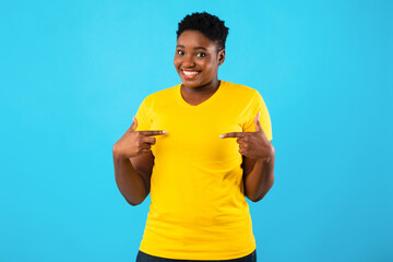 Oversized African Lady Pointing Fingers At Herself Over Blue Background