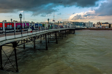 Obraz premium A view from the pier towards the town of Worthing, Sussex, UK at sunset
