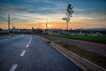 photo of road leading to town at the end of the day watching the sunset