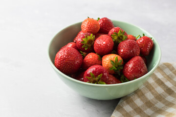 Whole strawberries in a mint bowl