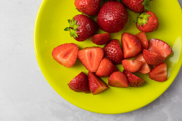 Top view of whole and sliced strawberries.