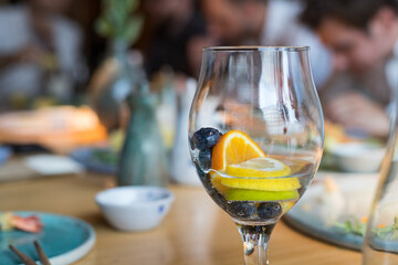 A glass of water and fruit in a restaurant.