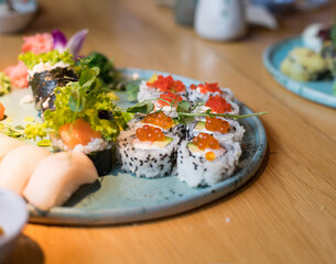 A plate of sushi. Different types of Japanese food. Delicious food in the restaurant during the meeting.