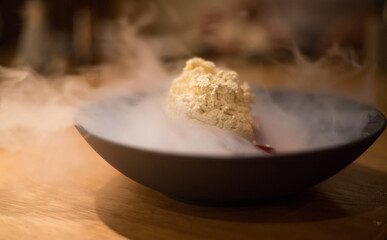 Japanese dessert in a sushi restaurant. Steam rising from the dessert. dark culinary photography.