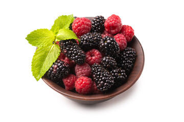 Raspberry, blackberry and mint leaf in ceramic brown bowl isolated on white
