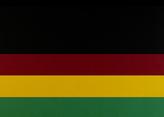 February Black History Month. Brown wooden hand on Paper geometric black, red, yellow, green background. Copy space, place for your text.
