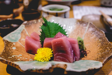 Japanese tuna sashimi in traditional pottery at wood table, Kyoto, Japan