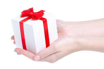 White gift box with red ribbon in hand on white background isolation