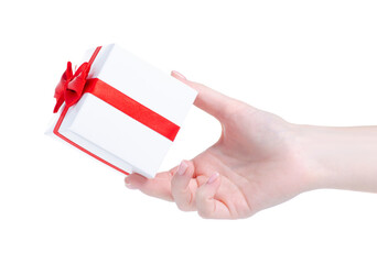 White gift box with red ribbon in hand on white background isolation