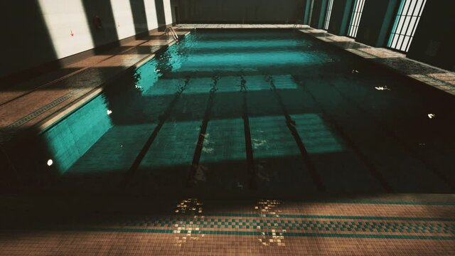 The view of an empty public swimming pool indoors