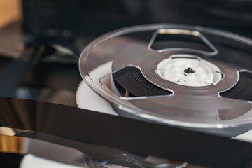 A disassembled old video cassette with a film lies on the table. Outdated technology.