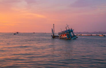 an old ship during the sunset on the sea in the Gulf of Thailand