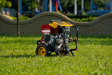 Motor pump on the lawn. Plumbing Tools. Everything for cleaning the sewer.