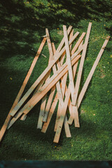 Old planks laying in grass, random pile