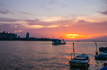 an old ship during the sunset on the sea in the Gulf of Thailand