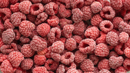 Background of frozen raspberries, healthy food concept, Ripe raspberries with frosty freshness.