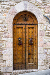 Typical door of a medieval palace in the ancient town of Assisi, in Umbria (Italy)