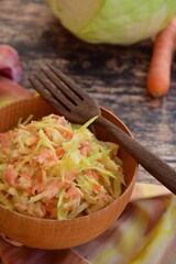 Coleslaw made of freshly shredded white cabbage and grated carrot with homemade vegan mayonnaise salad dressing