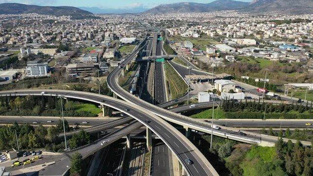 Aerial drone time-lapse video of motorway multilevel junction crossing through national road during rush hour