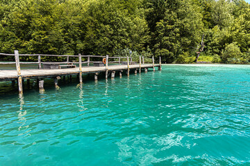 Wooden pier on a calm evening lake.