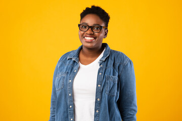 Cheerful Overweight African American Lady Posing Over Yellow Background