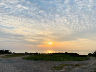 Beautiful pink orange sunset with sun rays over sea.