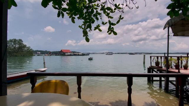 Scenic View Of The Pulau Ubin Jetty On A Tranquil Sea From A Restaurant In Singapore - Wide Shot (Static)