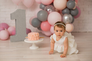Fototapeta na wymiar Baby girl at first birthday with smash cake