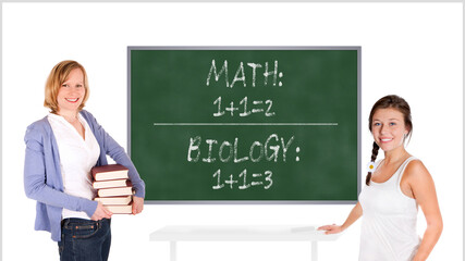 Young teacher and schoolgirl in front of a chalkboard, math one plus one equals two and biology one plus one equals three is written on the board, isolated on white background