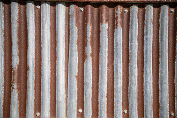 Weathered corrugated steel background with rust.