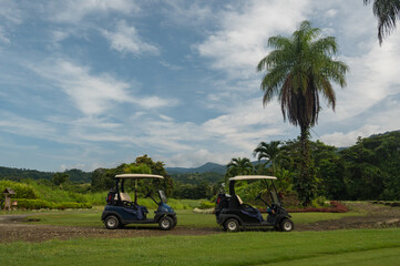 Two golf buggies on a fairway San Buenas golf course tropical Costa Rica 