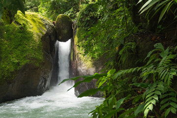 Waterfall with a boulder in the jungle near Uvita Costa Rica