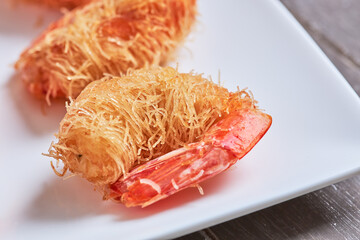 Close-up of kataifi-style breaded prawns.