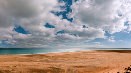 Fototapeta na wymiar Amazing beach with endless horizon. Background and Atlantic Ocean. Beach, Fuerteventura, Canary Islands, Spain