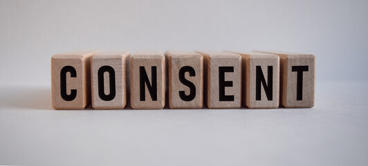 word CONSENT, inscription on wooden cubes on white background