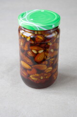 Nuts in honey in a glass jar