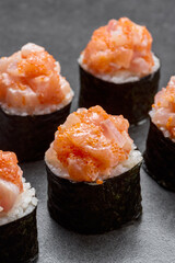 Sushu set with salmon, tuna, philadelphia cheese and rice on the dark background